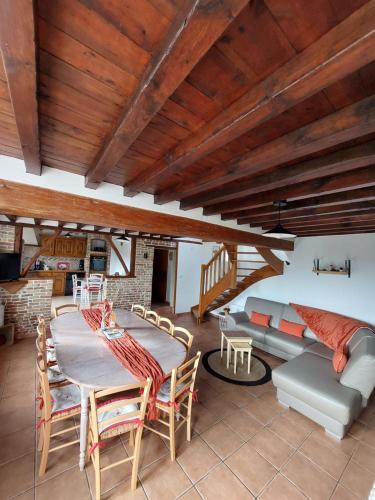 un salon avec une table et un canapé dans l'établissement Les Coquelicots, à Lacres