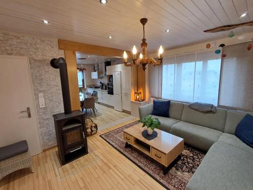- un salon avec un canapé et une cuisinière dans l'établissement Gîte du Verre au Sabot 5 étoiles avec spa privatif, à Soucht