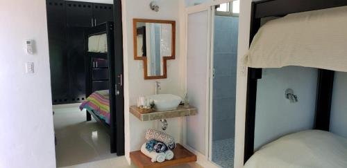 a bathroom with a sink and a mirror at Casa Mango in Valladolid