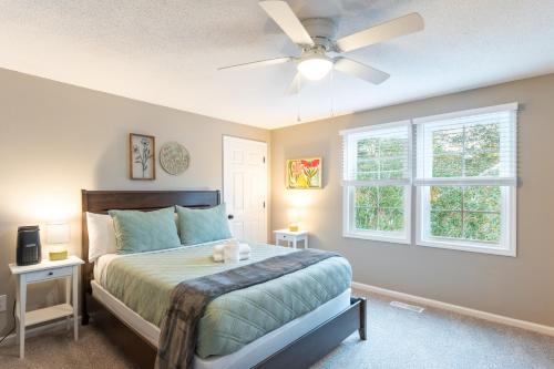 a bedroom with a bed and a ceiling fan at 8-Guest Cozy Escape with Fire Pit & Hot Tub! in Pawleys Island