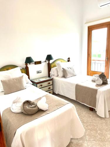 a room with two beds with towels on them at Villa Tonia in Cala en Blanes