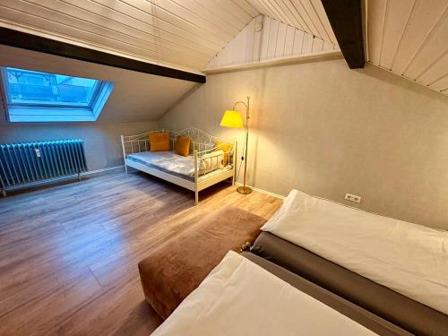 a bedroom with a bed and a window in a room at RelaxStay - Maisonette - Smart-TV- WIFI in Dielheim