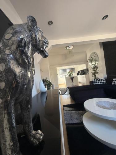 a statue of a dog in a living room at Luxury Studio Black & White in Sarajevo