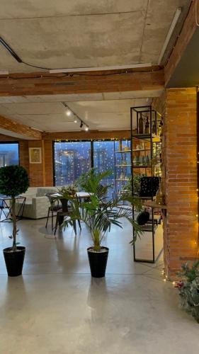 a large room with potted plants in a building at Mgzavrebi 10 in Bakuriani