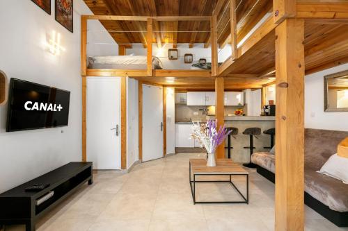 a loft apartment with a bed and a living room at Magnifique studio Hypercentre Trains Plages au cœur de Golfe-Juan in Golfe-Juan