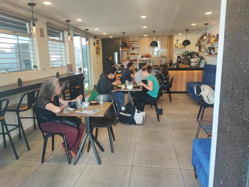 a group of people sitting at tables in a restaurant at Maison Lapinou in Momoxpan