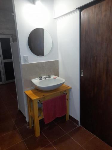 a bathroom with a sink and a mirror on a table at Oasis del sauce in Paraná