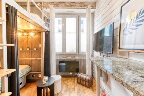 une petite chambre avec un lit et une télévision dans l'établissement Le Capitaine - Gare SNCF - Quartier calme, à Angers