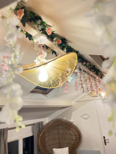 - un plafond avec un grand ventilateur et des fleurs dans l'établissement Romantique Appartement 10 min from Paris, à Vitry-sur-Seine