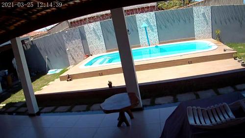 a pool with a wooden deck and a tub at Casa de Alicia in Prado