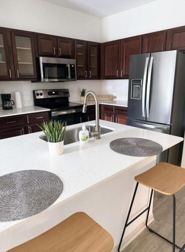 a kitchen with a sink and a refrigerator at 1 bed1 bath in frisco in Frisco