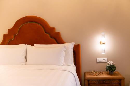 a bedroom with a bed with white sheets and pillows at Palazzo Doni by Florence Art Apartments in Florence