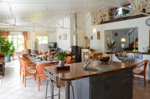 une cuisine et une salle à manger avec une table et des chaises dans l'établissement Domaine de la Moretie, à Cublac