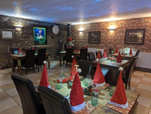 a restaurant with a table with red caps on it at White Swan Inn in Belford