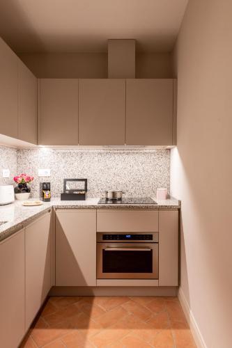 a kitchen with white cabinets and a stove at Palazzo Doni by Florence Art Apartments in Florence