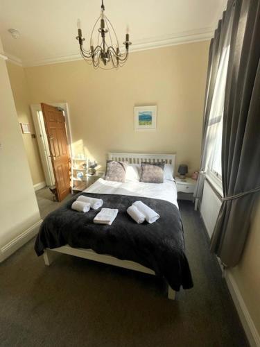 a bedroom with a bed with two towels on it at The Florence Guest House in Whitby
