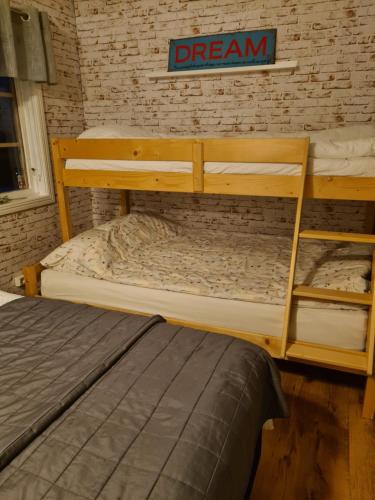 two bunk beds in a room with a brick wall at Guesthouse Fryken View 