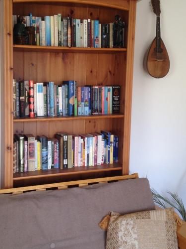a book shelf filled with lots of books at Rebels Hide -Self check in rooms in Penrith