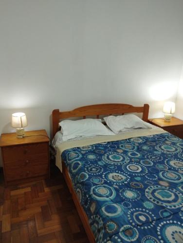 a bedroom with a bed and two night stands at Casa da estação in Afife