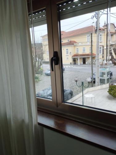 a window with a view of a street at Casa da estação in Afife