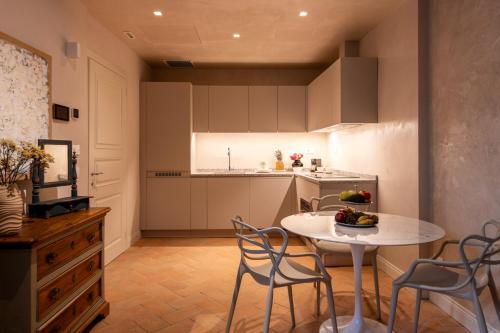 a kitchen and dining room with a table and chairs at Palazzo Doni by Florence Art Apartments in Florence