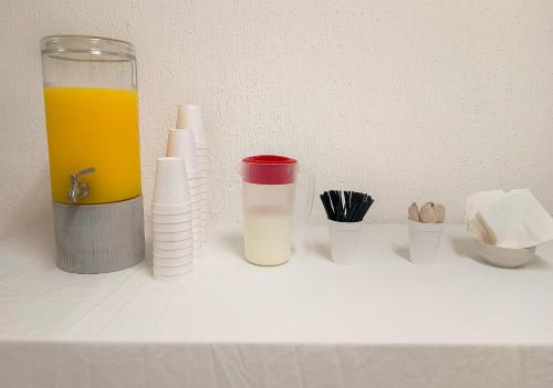 a table with a glass of orange juice and other containers at Hotel Imperial Laguna Faranda Cancún in Cancún