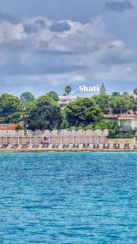 a resort on a beach with chairs and the water at Shati Luxury - New, Heated Pool, Sea view Near beach in Fontane Bianche