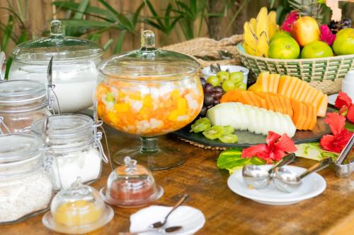 a table with a buffet of food and fruit at CasaLô Hotel in Jericoacoara