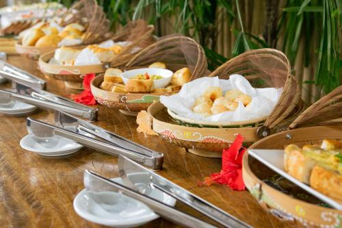 a table topped with baskets of food on a table at CasaLô Hotel in Jericoacoara