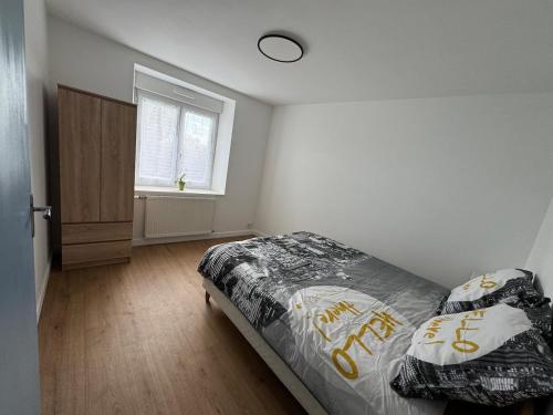 a bedroom with a bed and a window at Charmante maison en pierre in Saint-Eutrope