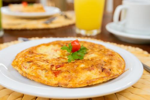 a white plate with a pizza on a table at CasaLô Hotel in Jericoacoara