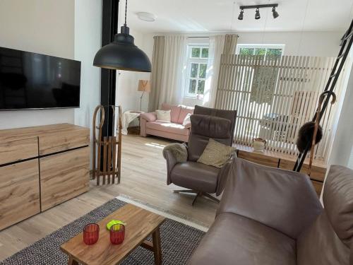a living room with a couch and a flat screen tv at Thüringer Wald-Zauber in Zella-Mehlis