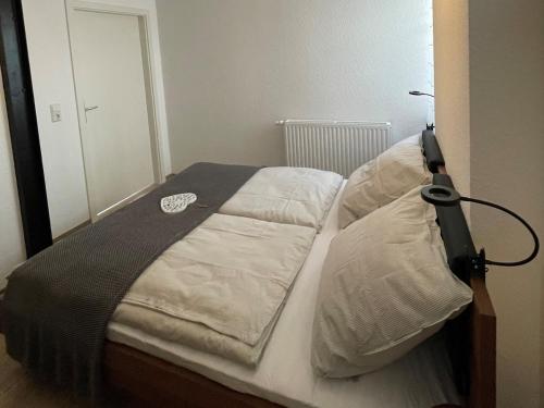 a bed with a black and white blanket and pillows at Thüringer Wald-Zauber in Zella-Mehlis