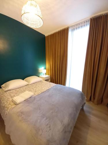 a bedroom with a large bed and a large window at Comfy Stay 9052 in Ghent