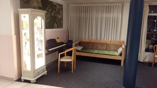 a small bedroom with a bed and a chair at Le Roi du Sundgau près de la Horse - Mooslargue in Mooslargue