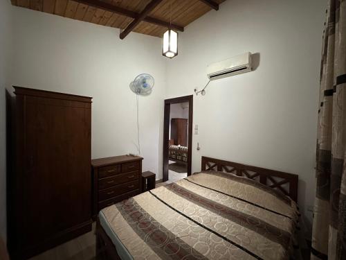 a bedroom with a bed and a dresser and a mirror at JaniGuest Villa in Wadduwa