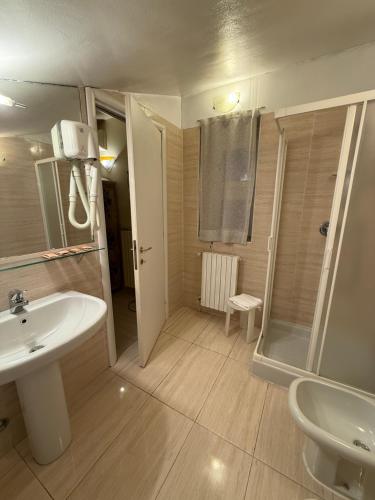 a bathroom with a white sink and a shower at Hotel Europa Fiera in Rho