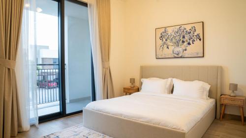 a bedroom with a bed and a large window at Luxury Villa In Yas in Abu Dhabi