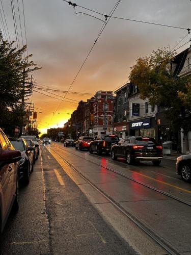 a city street with cars parked on the street at Queen Nest Hotel in Toronto