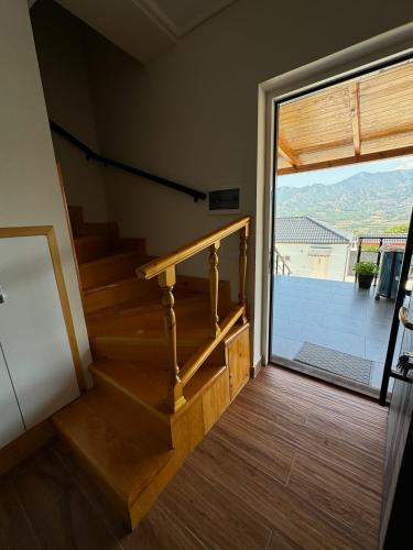 a staircase leading to a room with a sliding glass door at Villa Sana Rooms in Përmet