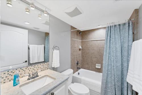 a bathroom with a sink and a toilet and a tub at 50 Meredith #7 in Manasota Key