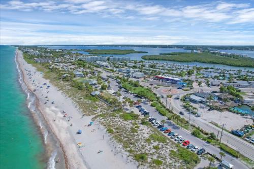 an aerial view of a beach with cars parked at 50 Meredith #7 in Manasota Key