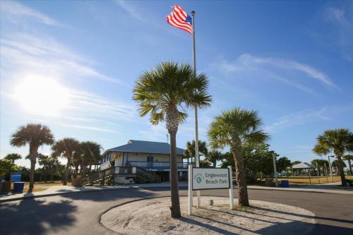 a american flag on a pole next to a sign at 50 Meredith #7 in Manasota Key