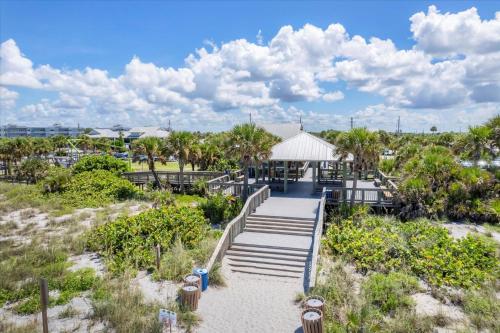 a boardwalk leading to a beach with palm trees at 50 Meredith #7 in Manasota Key