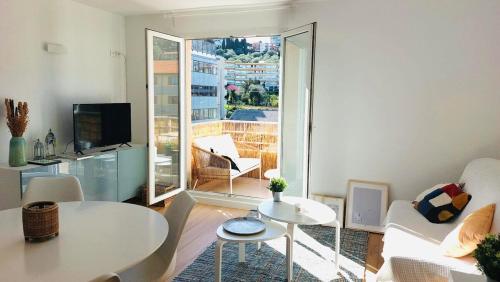 a living room with a couch and a table at Quartier de la plage in Roquebrune-Cap-Martin