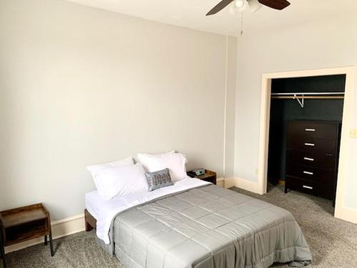 a bedroom with a bed and a ceiling fan at LG Lofts - 2 bedroom unit in Kiel close to Road America Elkhart Lake in Kiel
