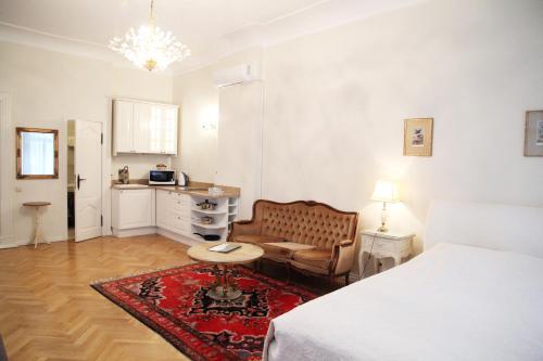 a bedroom with a bed and a couch and a table at Apartments - Laipu in Rīga