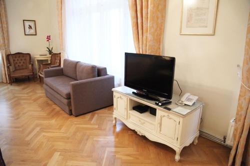 a living room with a television and a couch at Apartments - Laipu in Rīga