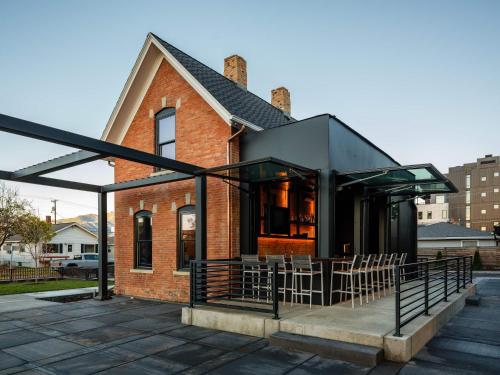 a brick house with a black roof and chairs at Unmatched Privacy & Luxury for the Entire Family in Bozeman