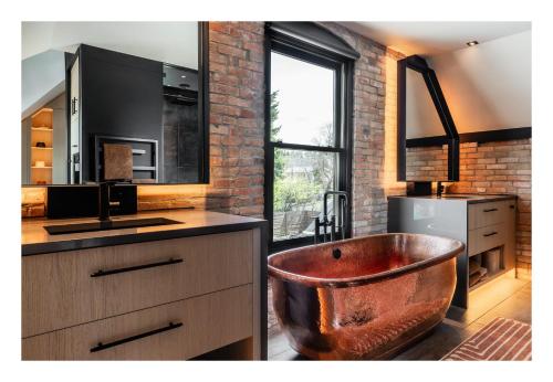 a bathroom with a copper tub in the middle at Unmatched Privacy & Luxury for the Entire Family in Bozeman